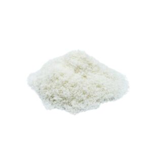 A pile of Coconut Flour is shown on a simple white background. Coconut Flour has a white, fluffy appearance with a slightly irregular texture indicating that it has been finely grated. The coconut appears fresh and unsweetened.