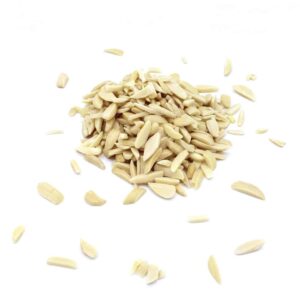 A pile of Peeled Stick Almonds is displayed against a pure white background. Peeled Stick Almonds, some scattered on the main pile, are thin, elongated slices that highlight their beige color and soft texture. The minimalist background emphasizes the natural appearance of the almonds.